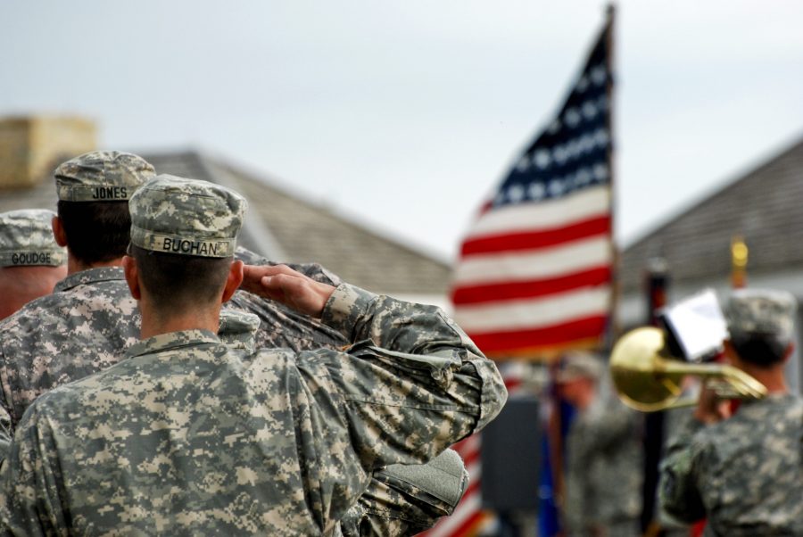 Soldiers of 1st Brigade Combat Team, 34th Infantry Division salute the American flag as the United States anthem is being played during their departure ceremony at historic Fort Snelling May 22, 2011. Image from Google Commons.