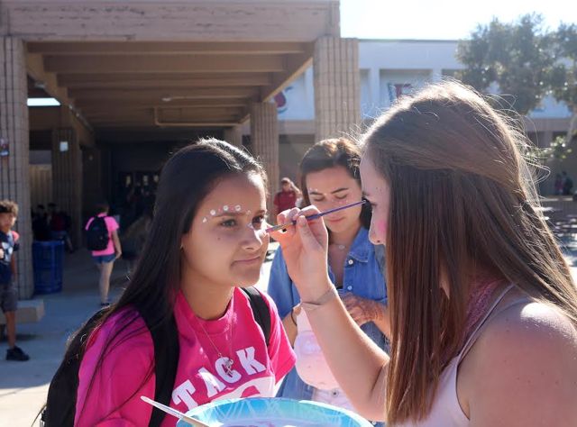 Sadie Arganda, junior, getting her face painted to support breast cancer. 