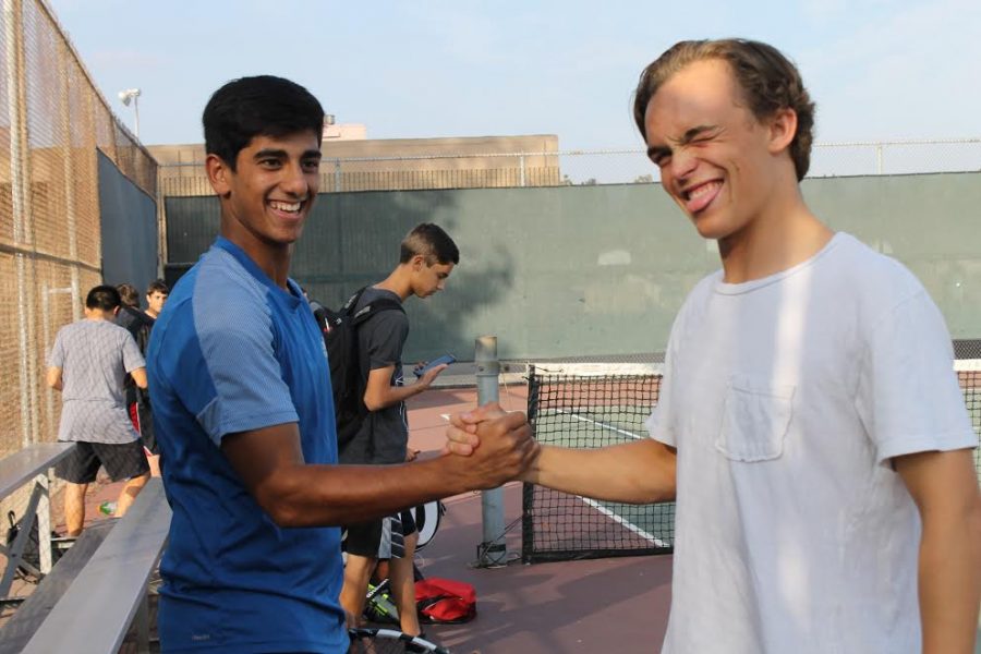 Mens tennis players share their special handshake pre-game to ensure another successful win. 