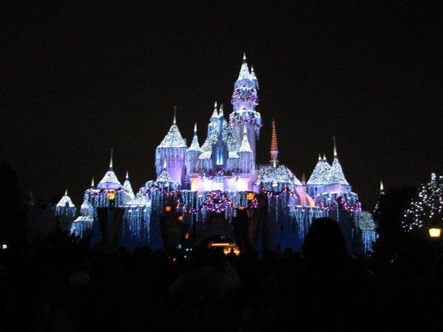 Disneyland celebrates the Christmas season by covering Sleeping Beautys castle in glittering lights.