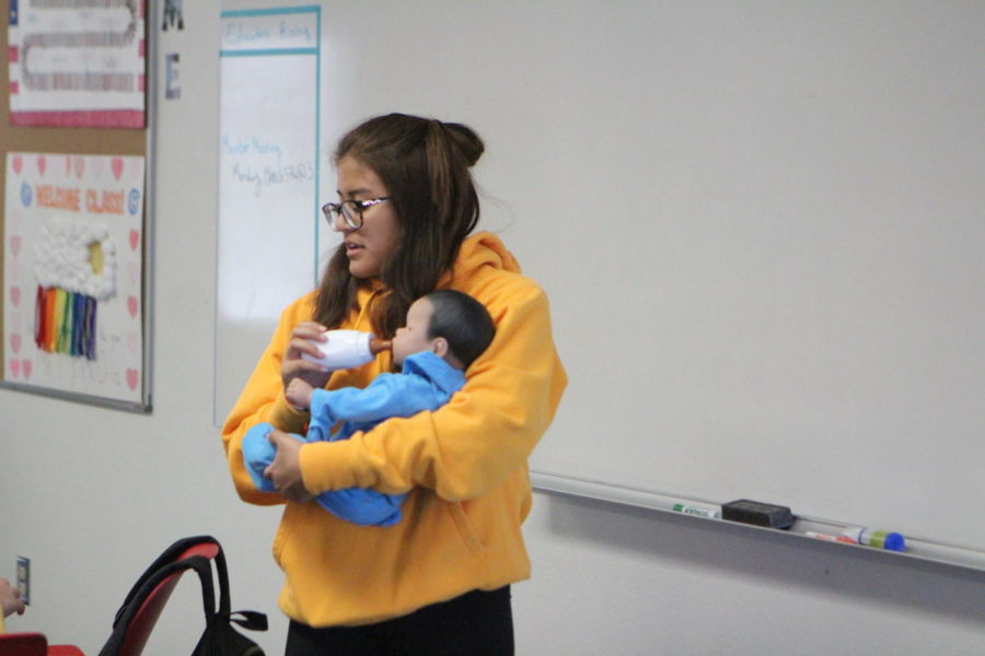 Marianna Frias, junior, taking care of her child development baby in 4th period last week. 