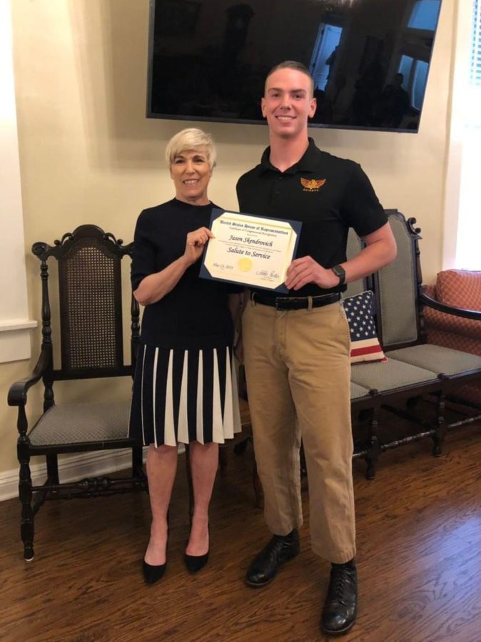 Senior Jason Skendrovich receiving his honorary congressional certificate from the Orange Assistance League at the Salute to Service dinner. The award honors high school enlistees to the military.