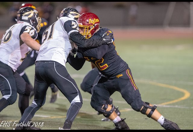 Varsity player Calvin Flores (junior) tackles an opposing player in the last season.