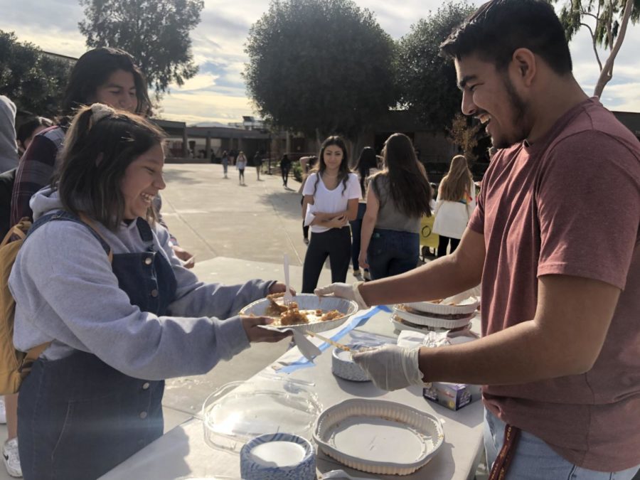Senior Julian Martinez passing out pumpkin pie for the 2nd day of ThankFALL Week.